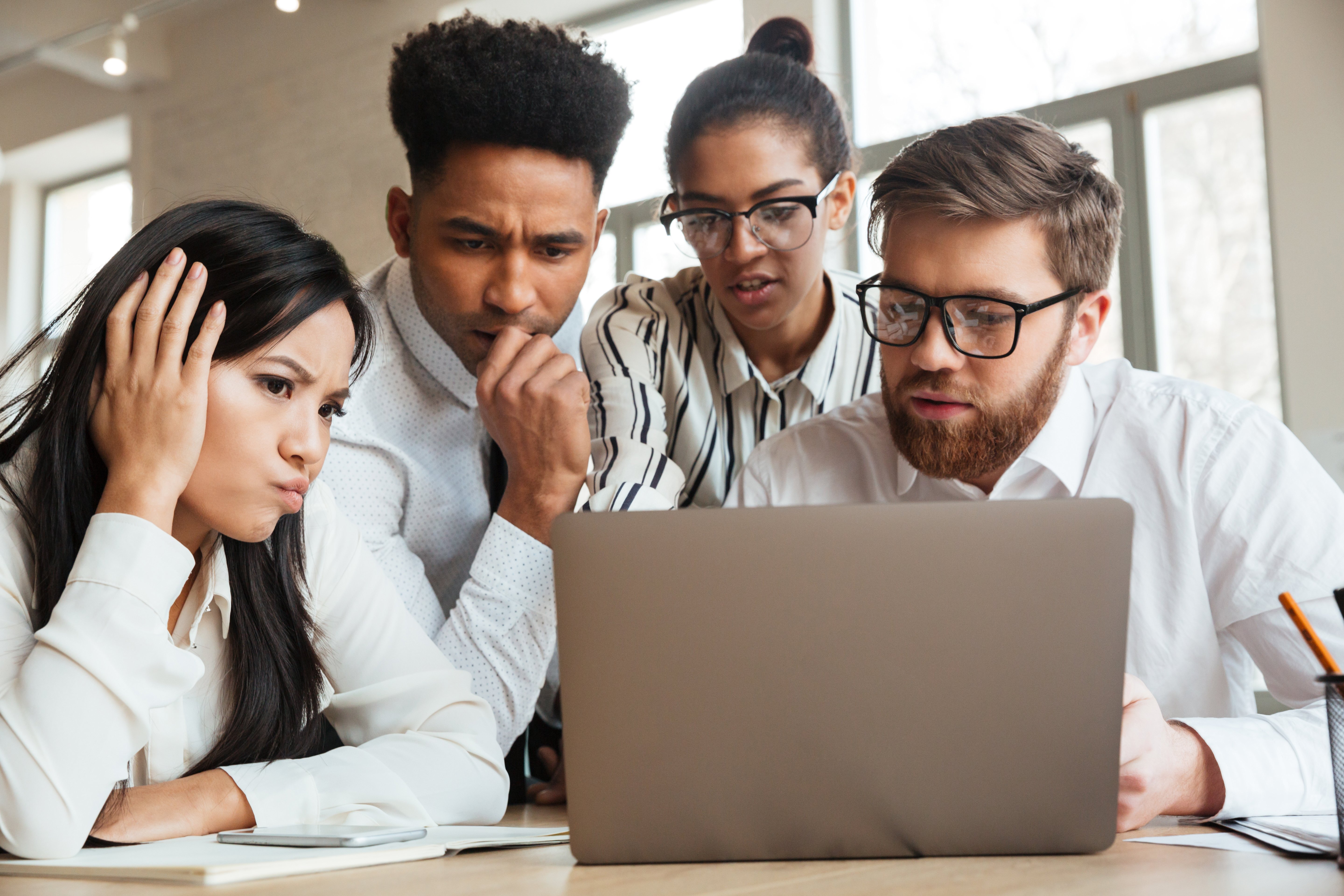 nervous-young-business-colleagues-using-laptop-computer